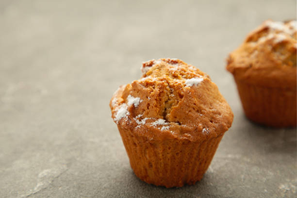 istock Vanilla muffins. Sweet cupcakes on grey background. Top view. 1404811684