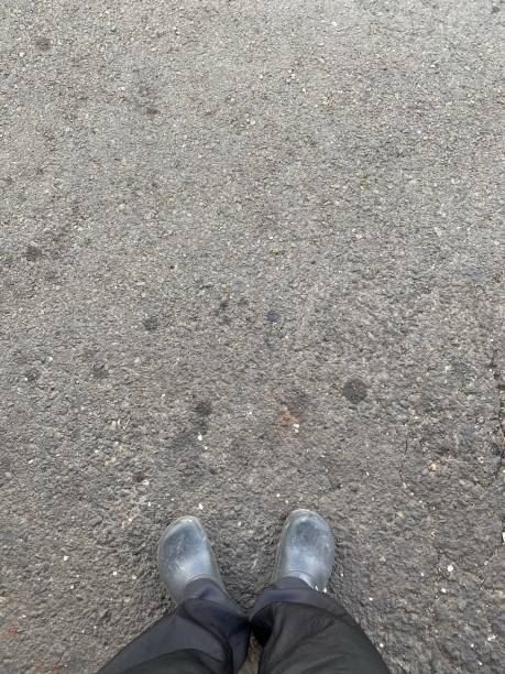 istock a pair of shoes on a paved road 1404816766