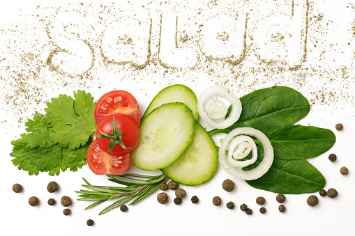 Vegetable salad ingredients in slices on white background