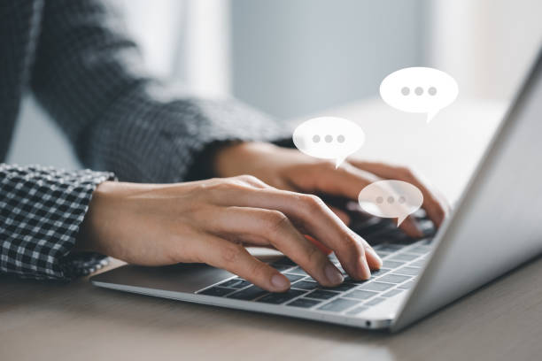 istock closeup woman hands typing on laptop with message icon as chatting 1404819453
