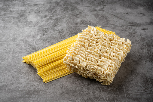Pasta Noodles for cooking Italian food in plastic bag on white background.