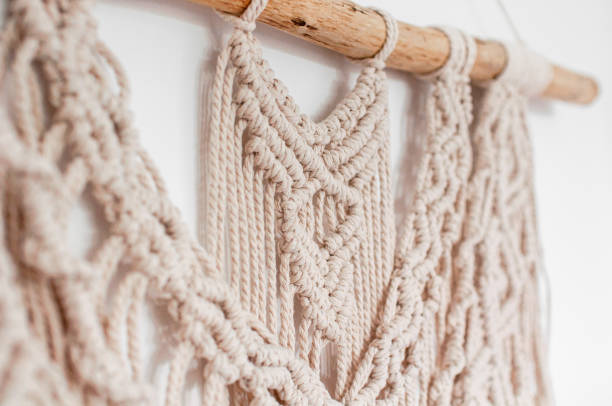 istock Wall decor in the style of weaving macrame handmade from beige natural threads 1404821185