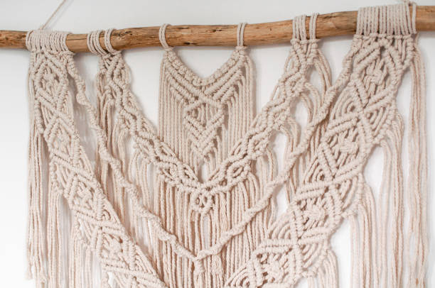 istock Wall decor in the style of weaving macrame handmade from beige natural threads 1404821189