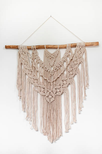 istock Wall decor in the style of weaving macrame handmade from beige natural threads 1404821195