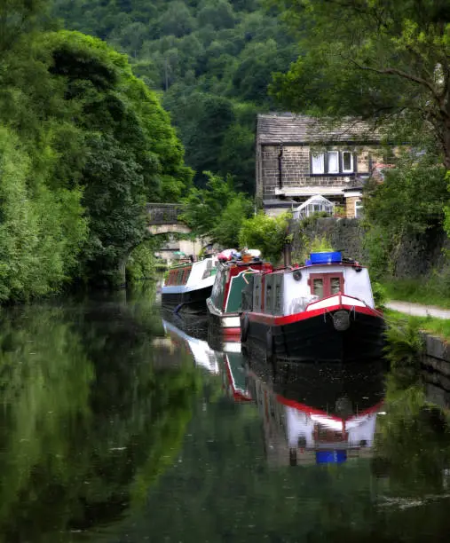 Canal scene with old mills barges and towpath