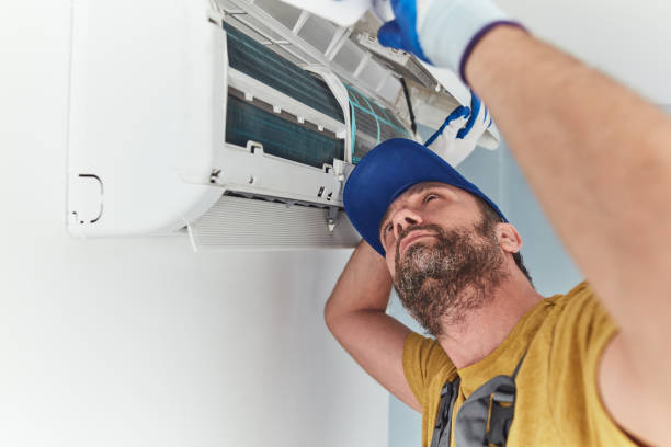 istock Repairman cleaning and fixing indoors AC unit. 1404822596