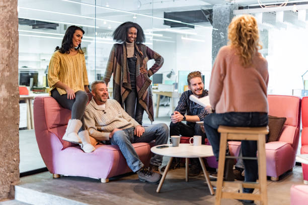 istock Group of happy business people talking on a constructive meeting in the office. 1404825764