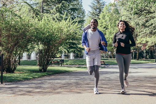 multi-ethnic runner couple joggin in park