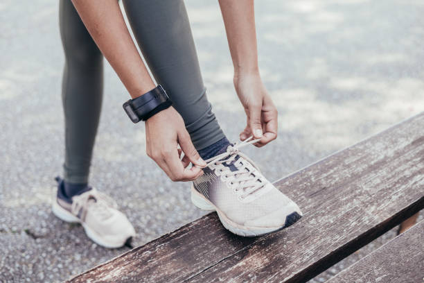 istock unrecgonizable asian runner tying shoelaces before joggin 1404825942
