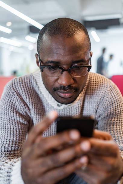 istock African American man text messaging on cell phone. 1404826743