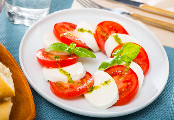 istock Caprese salad with fresh tomatoes, mozzarella cheese and basilic herb 1404826972