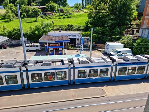 Zurich with Tram stop Waffenplatzstrasse seen from above. The image shoows a Tram of the Line 13 captured during springtime.