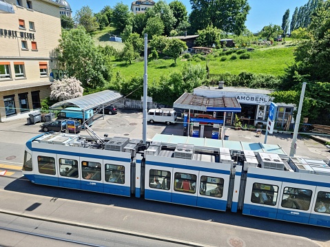 Zurich with Tram stop Waffenplatzstrasse seen from above. The image shoows a Tram of the Line 13 captured during springtime.