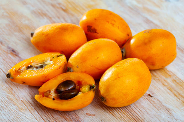 istock Whole and halved loquat fruits 1404827214