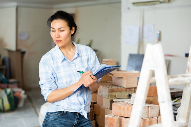 istock Woman checks the completed construction work on drawing 1404827946