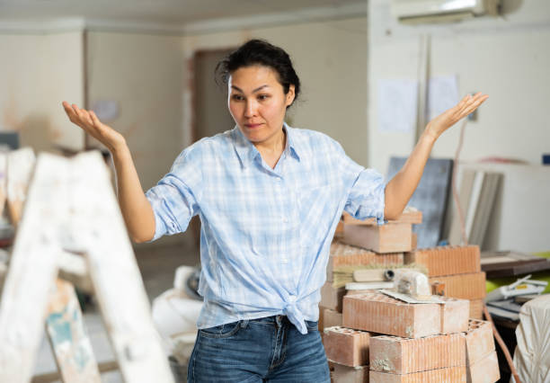 istock Frustrated woman standing at indoor construction site 1404827968