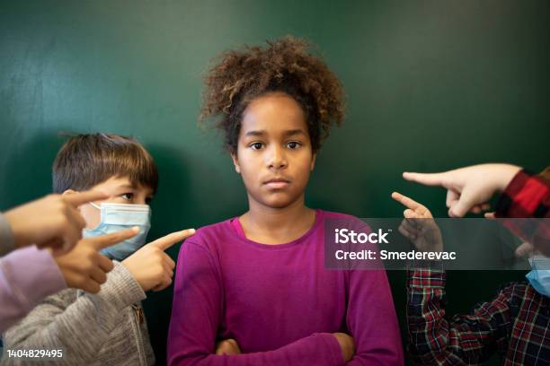 Schoolchildren Discrimination And Harassment For Not Wearing Face Mask During Corona Virus Pandemic Stock Photo - Download Image Now