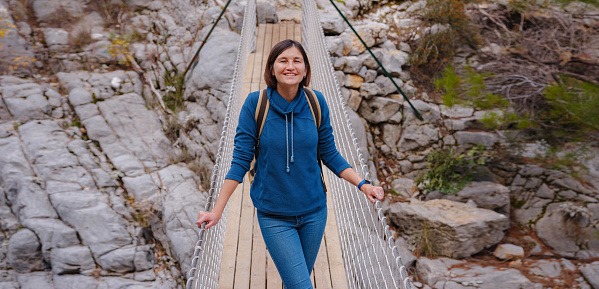 travel to Turkey, Kemer in autumn seasone. famous part of Lycian Way, Goynuk Canyon. Woman hiker trekking in mountains. Young lady walking with backpack in forest.
