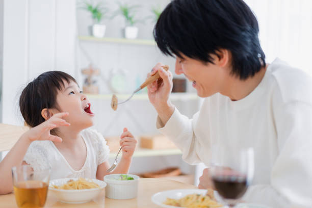 Little girl eating with daddy