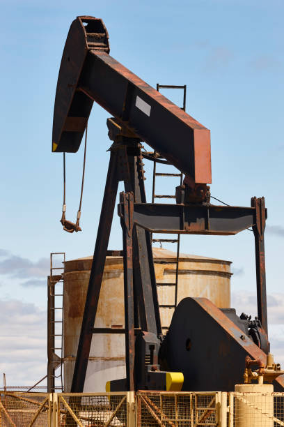 istock Rusty oil pumping machine. Pump jack. Petroleum extraction. Global warming 1404835009