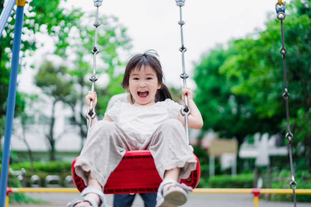 istock Little girl playing in the park with her daddy 1404836447