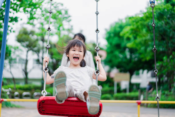 istock Little girl playing in the park with her daddy 1404836456