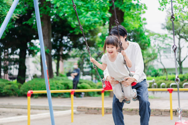 istock Little girl playing in the park with her daddy 1404836477