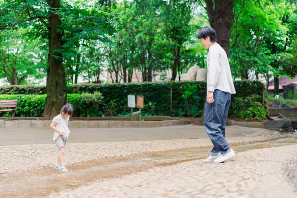istock Little girl playing in the park with her daddy 1404836480