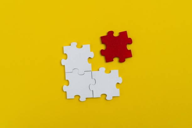 istock Four jigsaw pieces on yellow background 1404838800