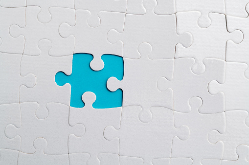 Blue puzzle as a bridge with a white parts on a white background