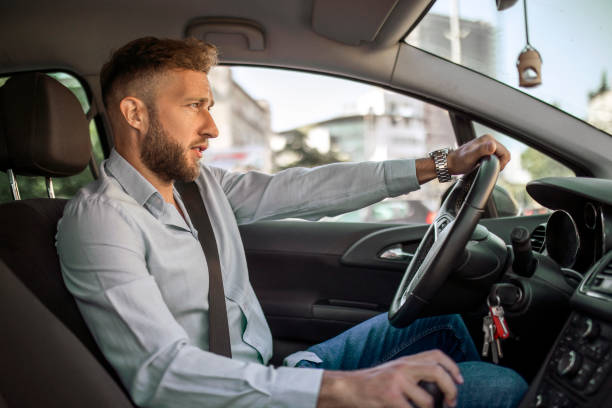 istock Serious businessman driving a car 1404839113