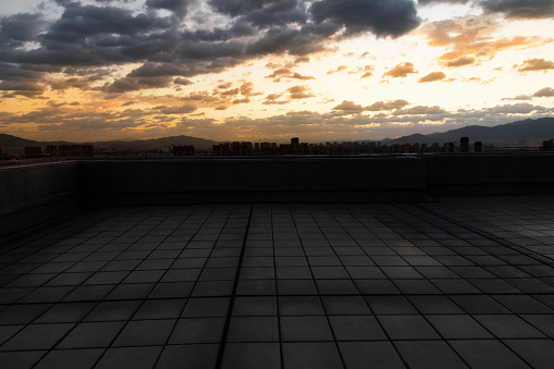 Modern building rooftop at sunset.