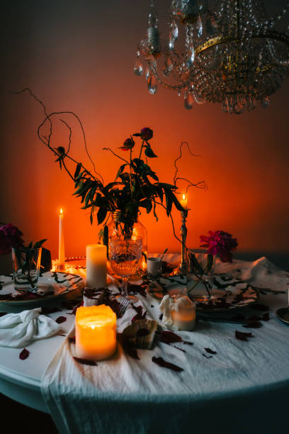 istock Table with candlesticks and flower bouquet in the dark. 1404842201