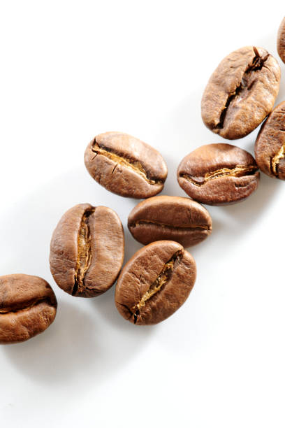 istock Roasted coffee beans isolated close up on white background, clipping path 1404843444