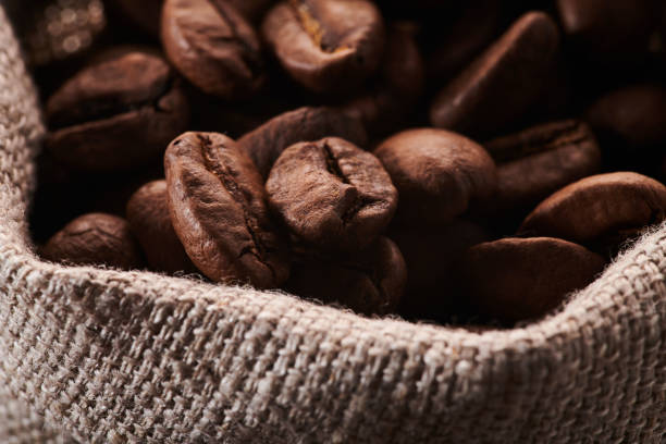 istock Roasted coffee beans in a bag closeup background 1404846645