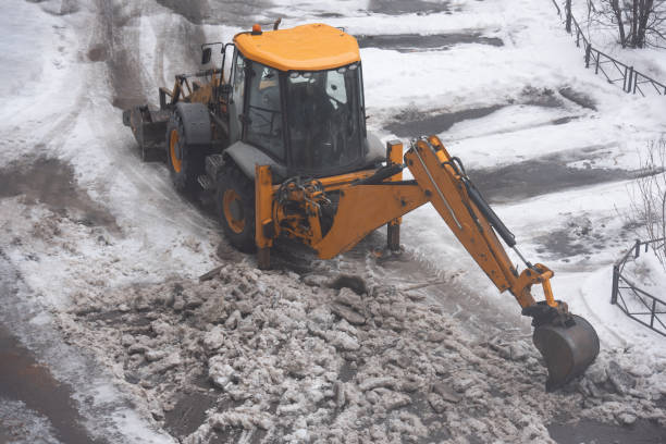 istock Excavator cleans street 1404848029