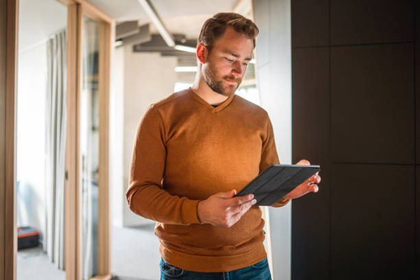 istock Young Male Freelancer And Professional Business Strategist Using A Tablet 1404848213