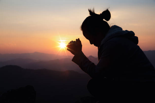istock woman worship on sunset 1404848254