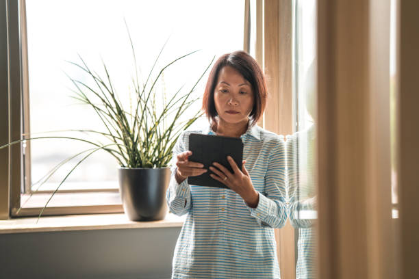 istock Mature Chinese Businesswoman Working With Digital Tools 1404848323