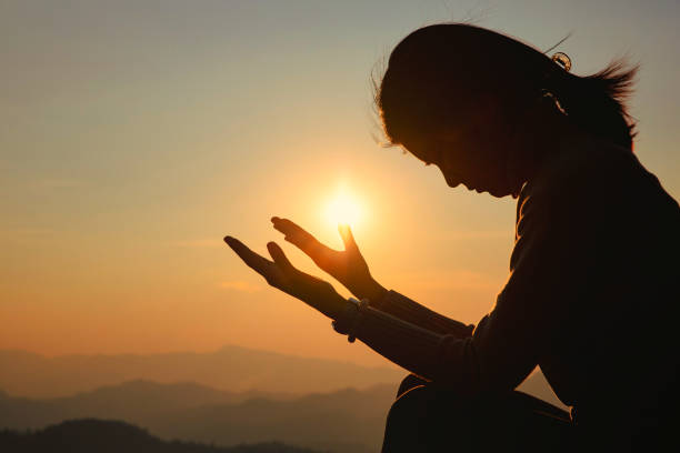 istock woman worship on sunset 1404848402
