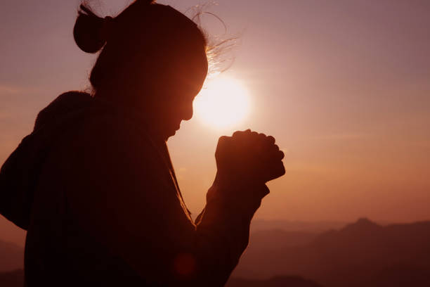 istock woman worship on sunset 1404848631