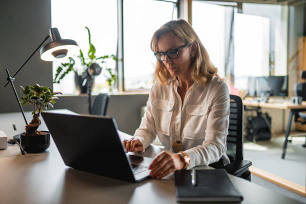 istock Mature Caucasian Female CEO Working In The Office 1404848716