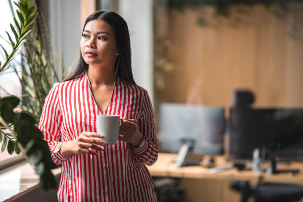 istock Young Japanese Female Secretary Taking A Coffee Break At Work 1404848748