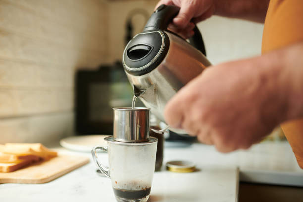 istock Man Pouring Hot Water in Phin Filter 1404848838