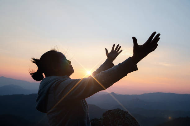 istock woman worship on sunset 1404848902
