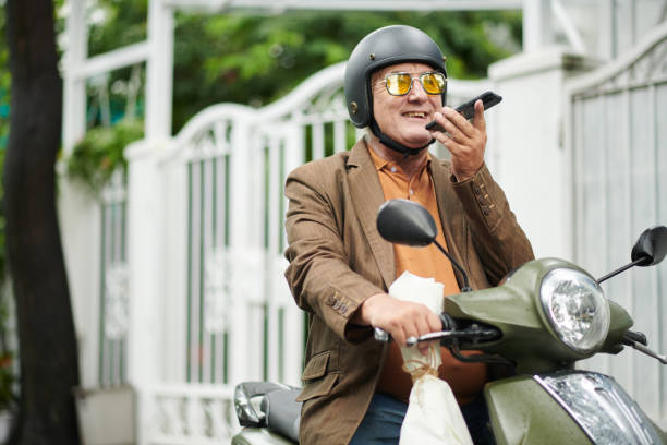 istock Man on Scooter Recording Voice Message 1404848953