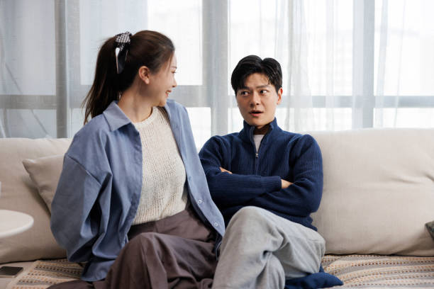 istock Young Asian couples sitting on the sofa talking 1404849706