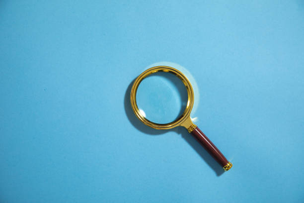 istock Magnifying glass on the blue background. 1404852809