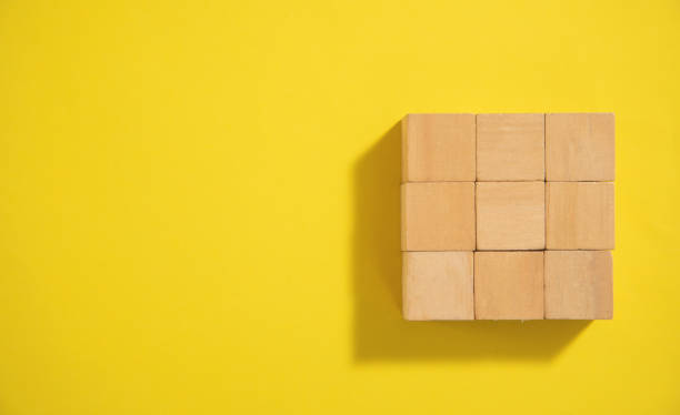 istock Wooden cubes on the yellow background. 1404852831