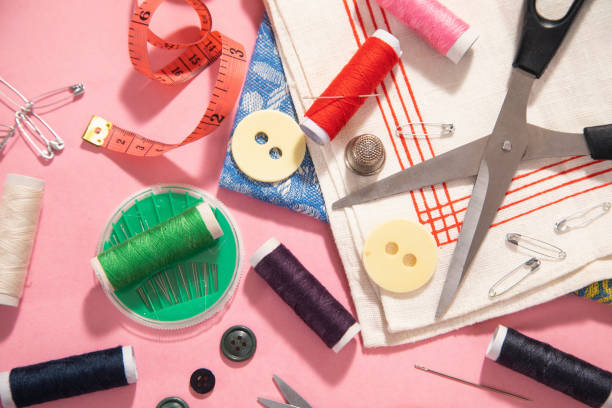 istock Sewing tools on the pink paper background. 1404852861